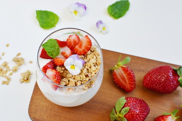Yogurt with granola, honey, blueberries and strawberries, healthy breakfast