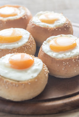 Egg-in-a-hole buns on the wooden board