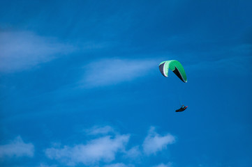 Paraglider flies paraglider in the cloudy sky. Paragliding.