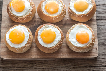 Egg-in-a-hole buns on the wooden board