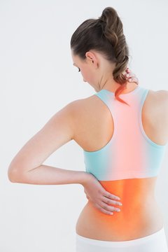 Rear view of woman suffering from back pain