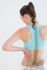 Rear view of woman suffering from neck pain