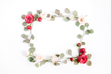 Border frame with red and beige rose flower buds and eucalyptus branches isolated on white background. Flat lay, top view. Floral background