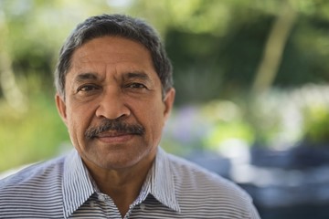 Portrait of serious man at porch