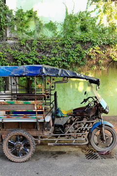 Old tuk-tuk parked on a street of downtown Vientiane-Laos. 4786