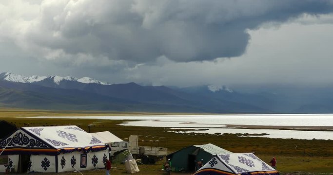 4k huge clouds mass rolling over lake namtso,tibet mansarovar,herdsman tent,a group of cow,Tibet's second largest lake,is the third largest saltwater lake in China.
