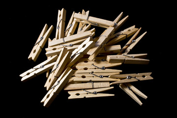Collection of Wooden Clothes pegs on Black Background