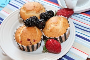 Fresh baked muffins with blueberries and strawberries