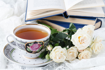 beautiful white cup of black coffee and rose flower on a white background