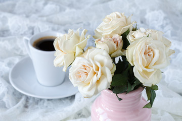 Cup of coffee on a table with flowers