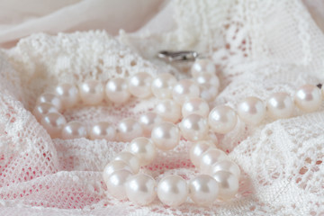 White pearls necklace on toilette table. Selective focus.