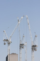 Fototapeta na wymiar Cranes in construction site for new apartments