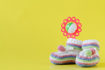 baby clothes with rattle in pastel color range