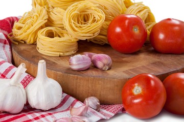 Raw fettuccine with tomatoes, garlic, onions and napkin cloth