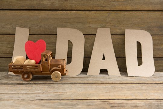 Text by heart shape in toy truck on table