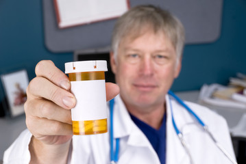 Doctor holding pill bottle