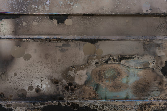 burnt corrugated lacquer colors on rusty metal surface, dull beige