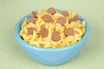 Bowl of macaroni and cheese with hotdog slices