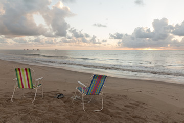 Fototapeta na wymiar Tambau beach - chairs on the beach - sunrise