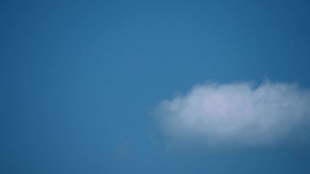 single white cloud against blue sky transition