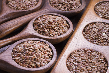 Flax seeds in wooden bowl and spoon