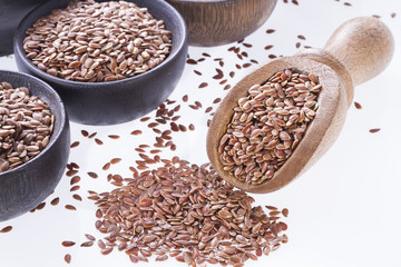 Flax seeds in wooden bowl and spoon