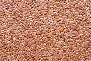 Flax seeds in wooden bowl and spoon