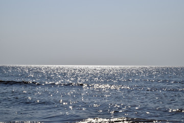 Sea line of the horizon. Sea and sky. The waves and glare of the sun are reflected from the waves...