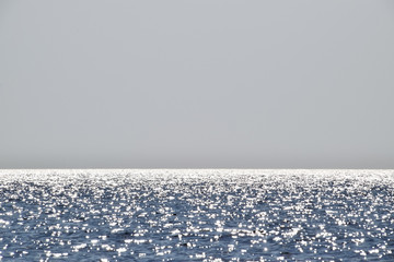 Sea line of the horizon. Sea and sky. The waves and glare of the sun are reflected from the waves...