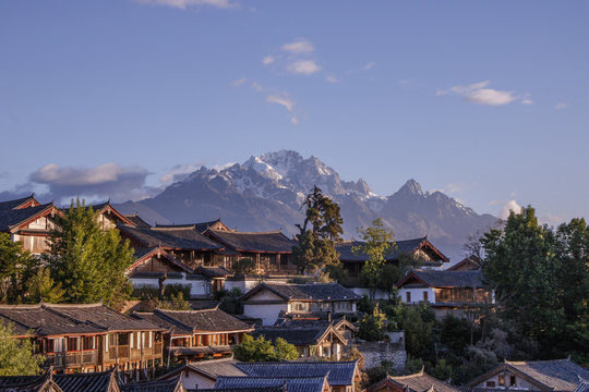 Blue sky traditional retro old Naxi house Yulong snow mountain in Lijiang old town, Yunnan Province, China