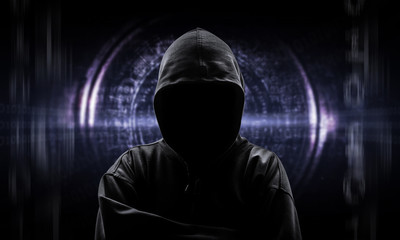 Silhouette of a hacker isloated on black with binary codes on ba