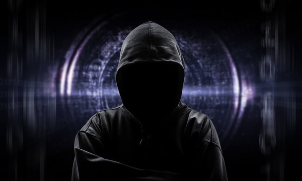 Silhouette of a hacker isloated on black with binary codes on ba