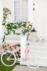 Obraz na płótnie Canvas White Bicycle near beautiful Flowers on vintage background in spring season