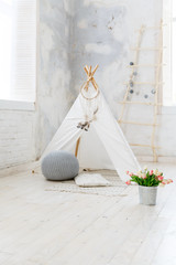 Children's hut in the room. Wigwam for kids in rustic style. Children room in loft or rustic style © Olga Mishyna