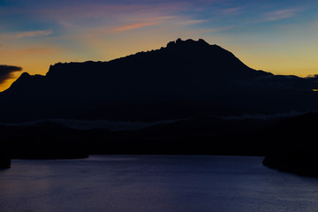 Beautiful sunrise over Mount Kinabalu and river Ganyang in Sabah, Malaysia. View point from Mengkabong bridge