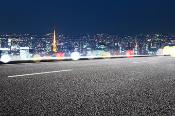 empty road with cityscape of tokyo at night