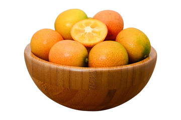 ripe kumquat fruit in wooden bowl isolated on white