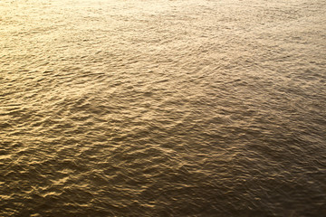 Surface of water in the river during the sunset background.