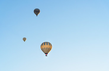 Hot air balloons flying over valley. Cappadocia. Turkey