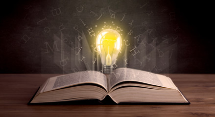 Letters and lightbulb over book