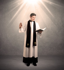 young priest in giving his blessing