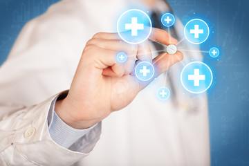 A doctor showing a pill with crosses