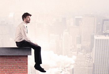 Office worker sitting on rooftop in city