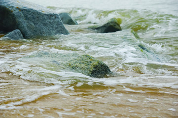ocean waves crashing on rocks on the shore
