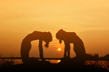 Fototapeta na wymiar Silhouette women yoga in nature ,color of vintage tone