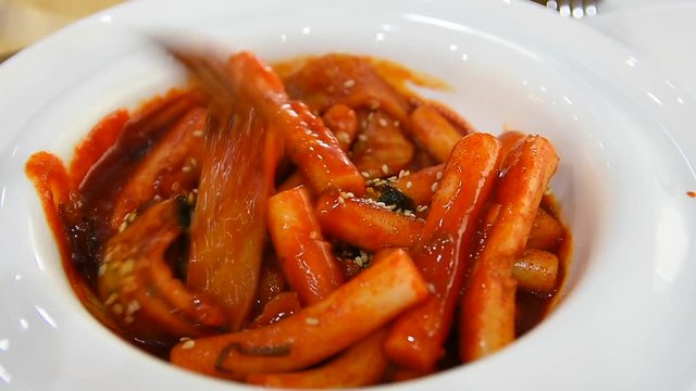 tteokbokki is a famous korean snack that consist of sticky rice, fish cake and gochujang