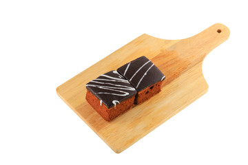 chocolate cake pour cream on cutting board  isolated  white background and clipping path. select focus with shallow depth of field