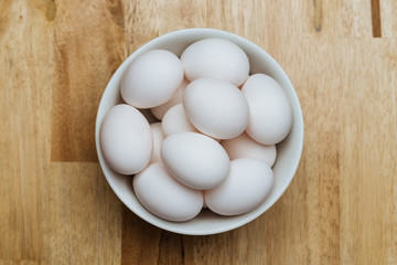 Chicken eggs in white bowl