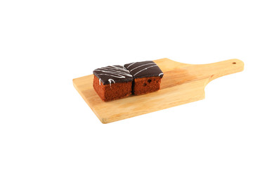 chocolate cake pour cream on cutting board  isolated  white background and clipping path. select focus with shallow depth of field