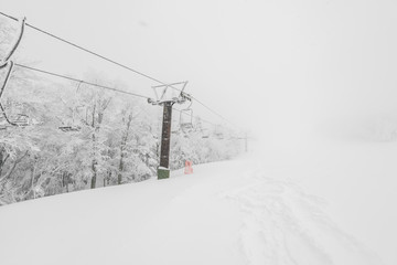 Ski lift over snow mountain in ski resort .